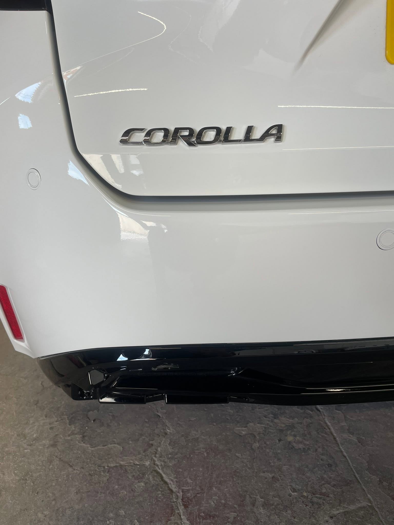 White Toyota Corolla rear quarter panel detail