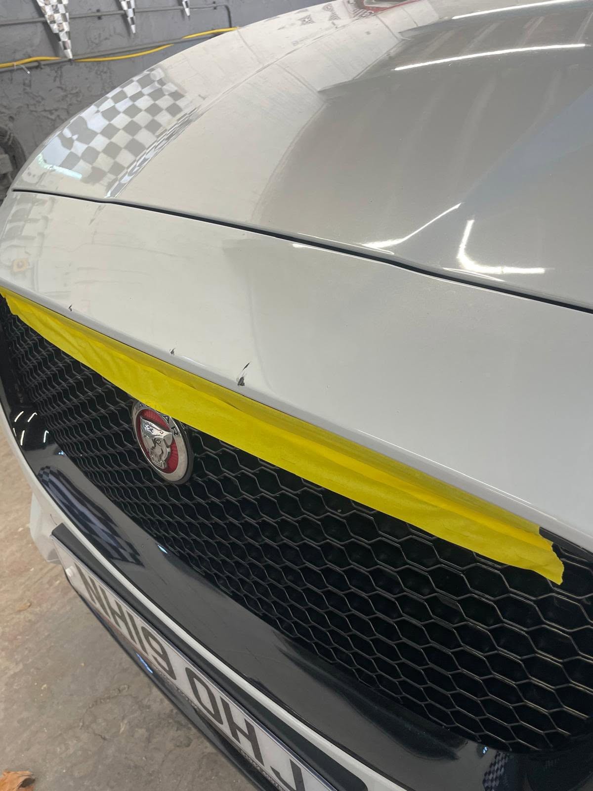 Custom car bonnet wrap with yellow stripe and checkerboard pattern