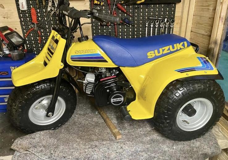 Yellow and blue Suzuki ATV in the workshop