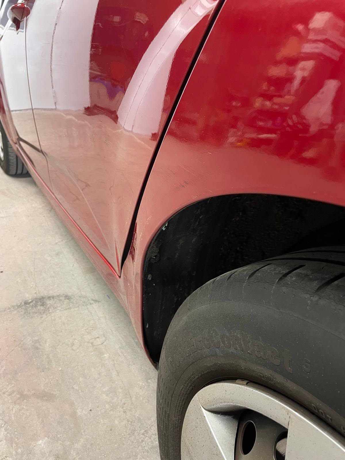 Red vehicle side panel before repair