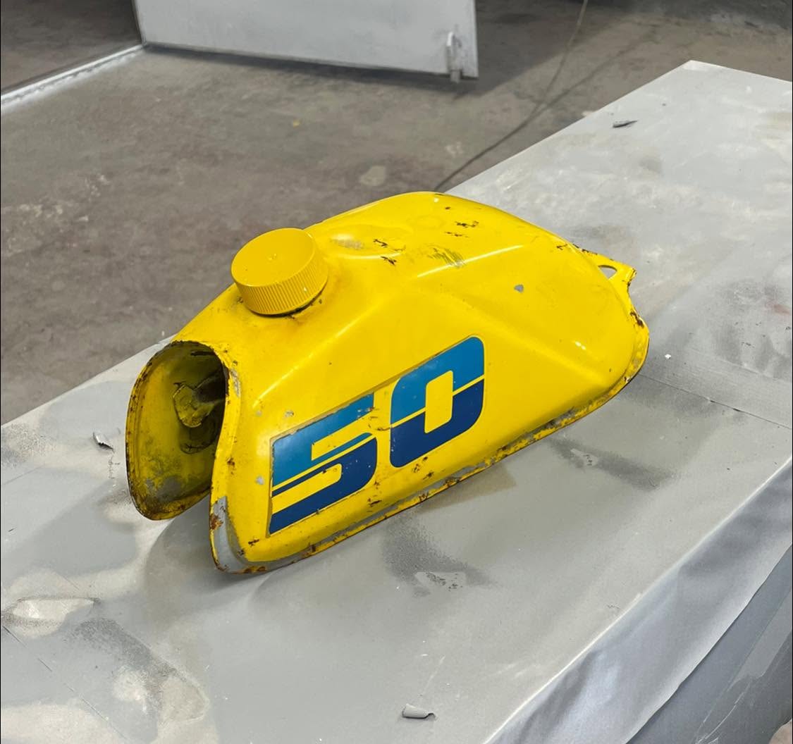 Yellow custom vehicle fuel tank with branding