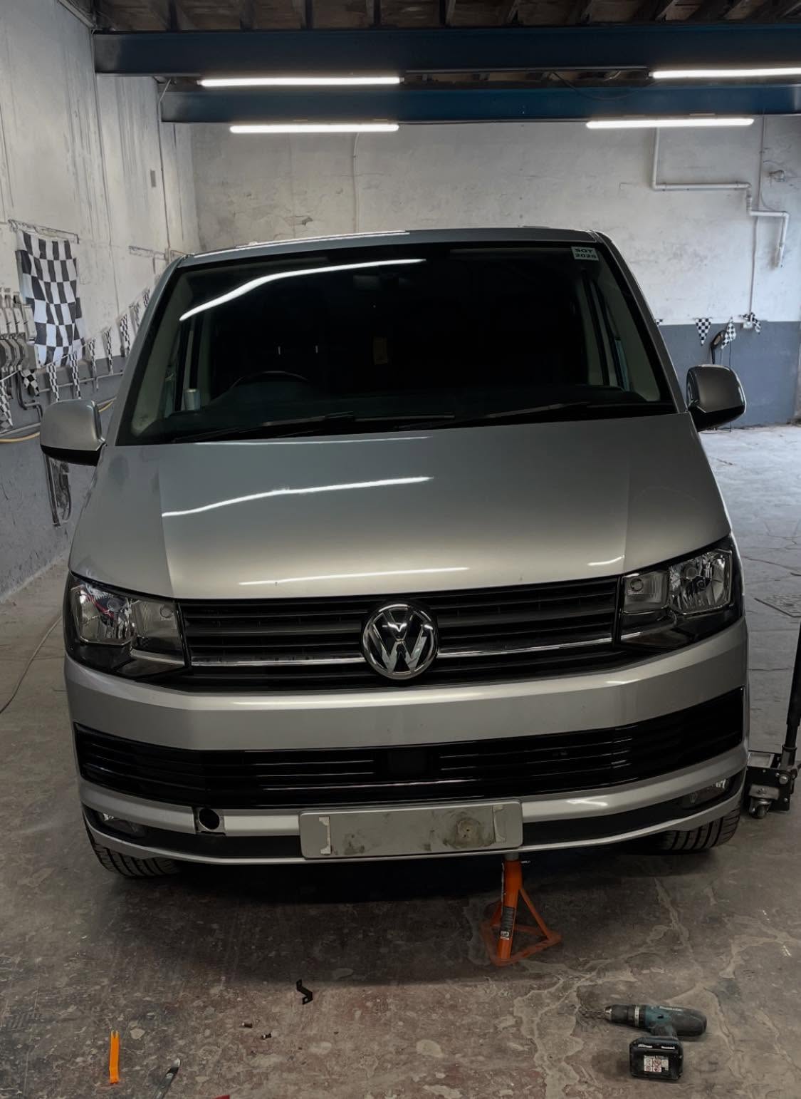 White Volkswagen van front view in the workshop